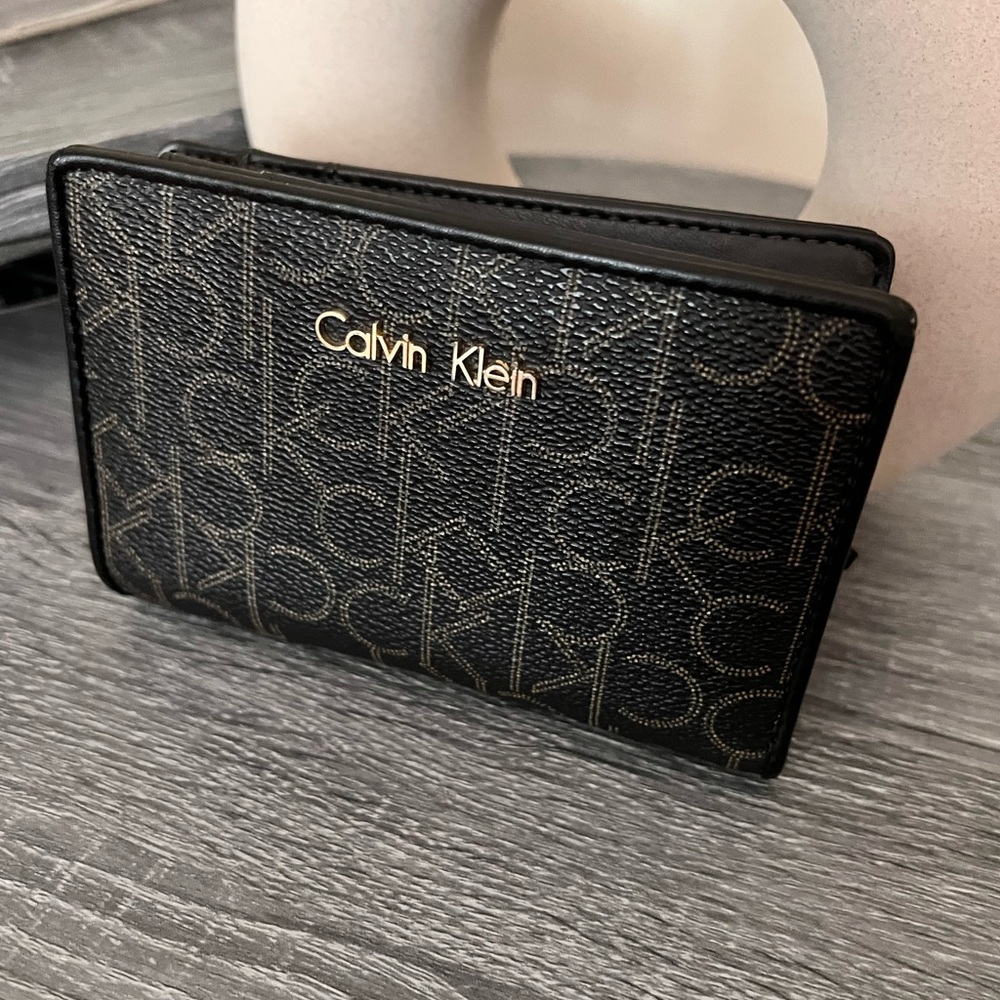 Calvin Klein Brown monogram Wallet with coins and bills slots.